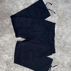 Black cargo pants with adjustable length straps